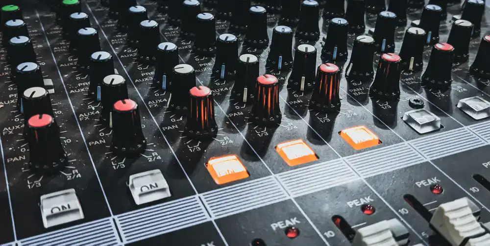 Moody studio photography featuring audio mixing equipment
