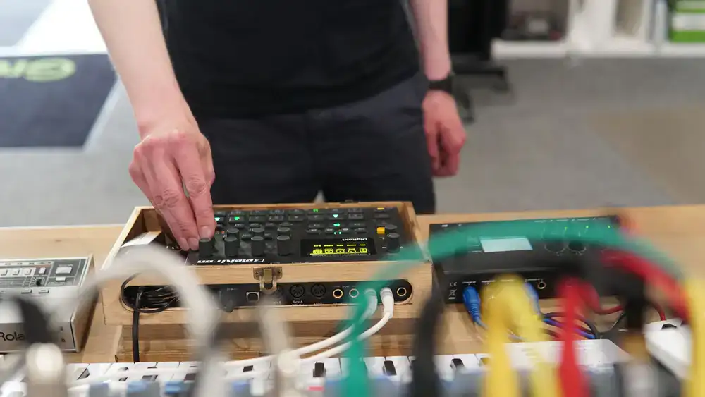 Sound designer adjusting hardware synthesizer